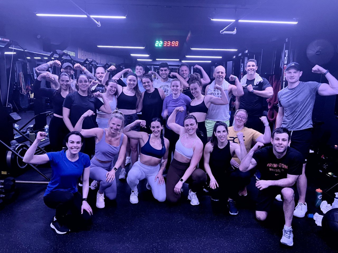 A packed BronCore Fitness group class celebrating together after a workout
